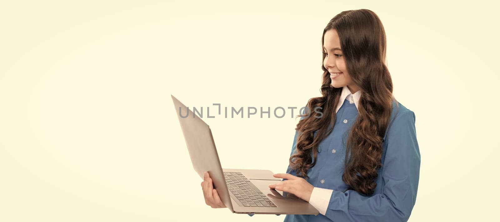 typing school blog on computer. kid on video lesson. teen girl use laptop for blogging. School girl portrait with laptop, horizontal poster. Banner header with copy space. by RedFoxStudio