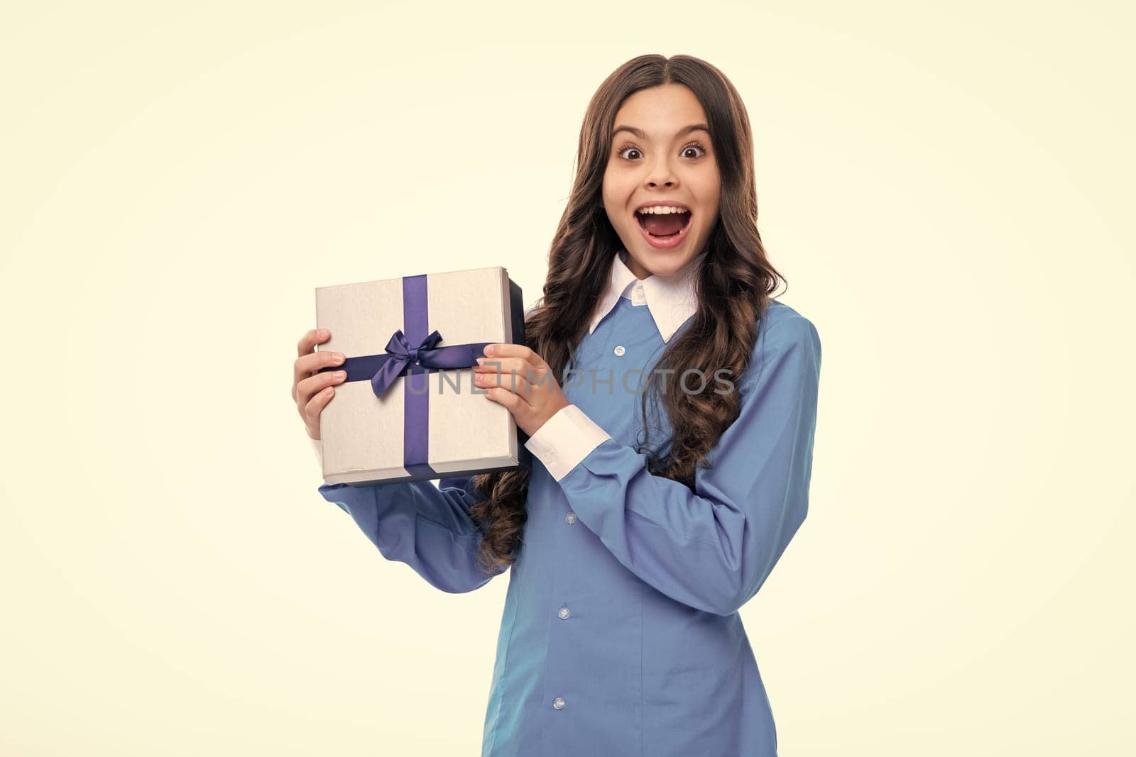 Emotional teenager child hold gift on birthday. Funny kid girl holding gift boxes celebrating happy New Year or Christmas. by RedFoxStudio