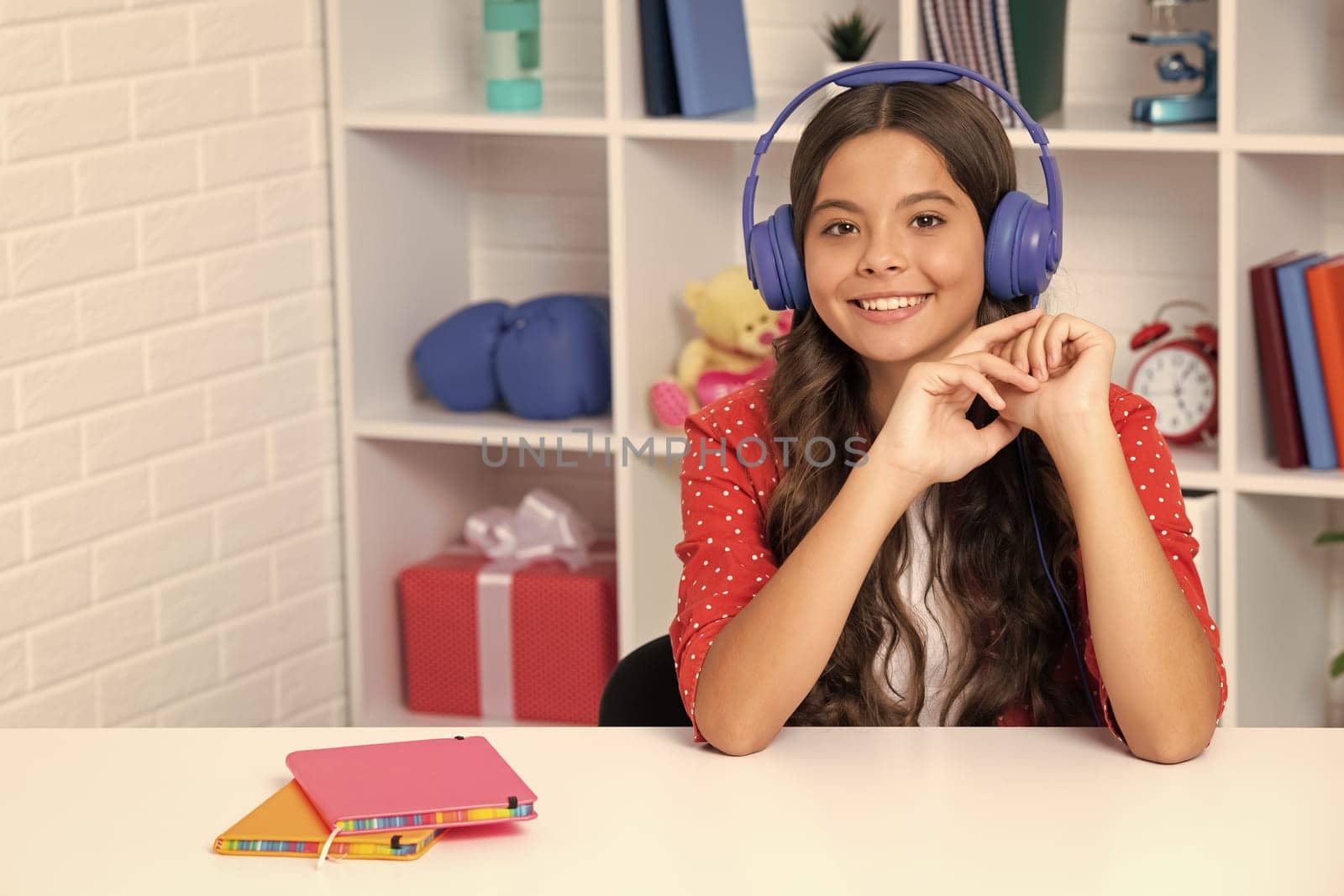 Teenager school girl listening music. Portrait of teen with headphone. Children, music, emotions concept. Excited schoolgirl. Happy girl face, positive and smiling emotions