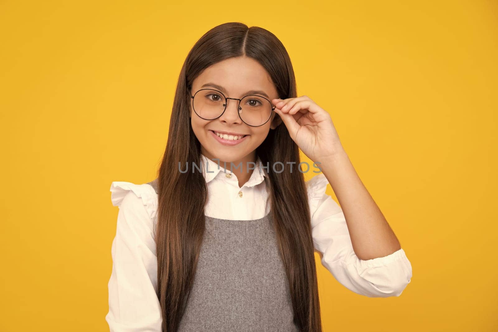 Portrait of teenager child girl in glasses. Kid at eye sight test. Girl with eyeglasses and looking at camera. Vision for children. Happy girl face, positive and smiling emotions