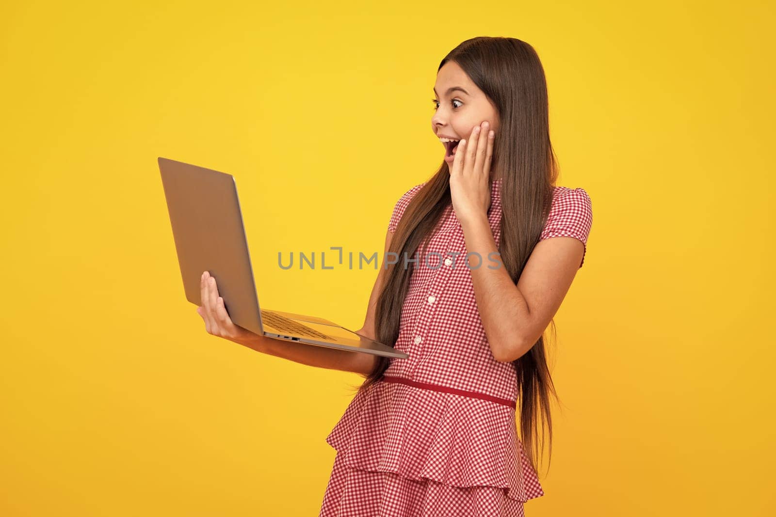 Amazed teen girl. Young student school girl, studying with laptop computer. E-learning concept. Excited expression, cheerful and glad. by RedFoxStudio