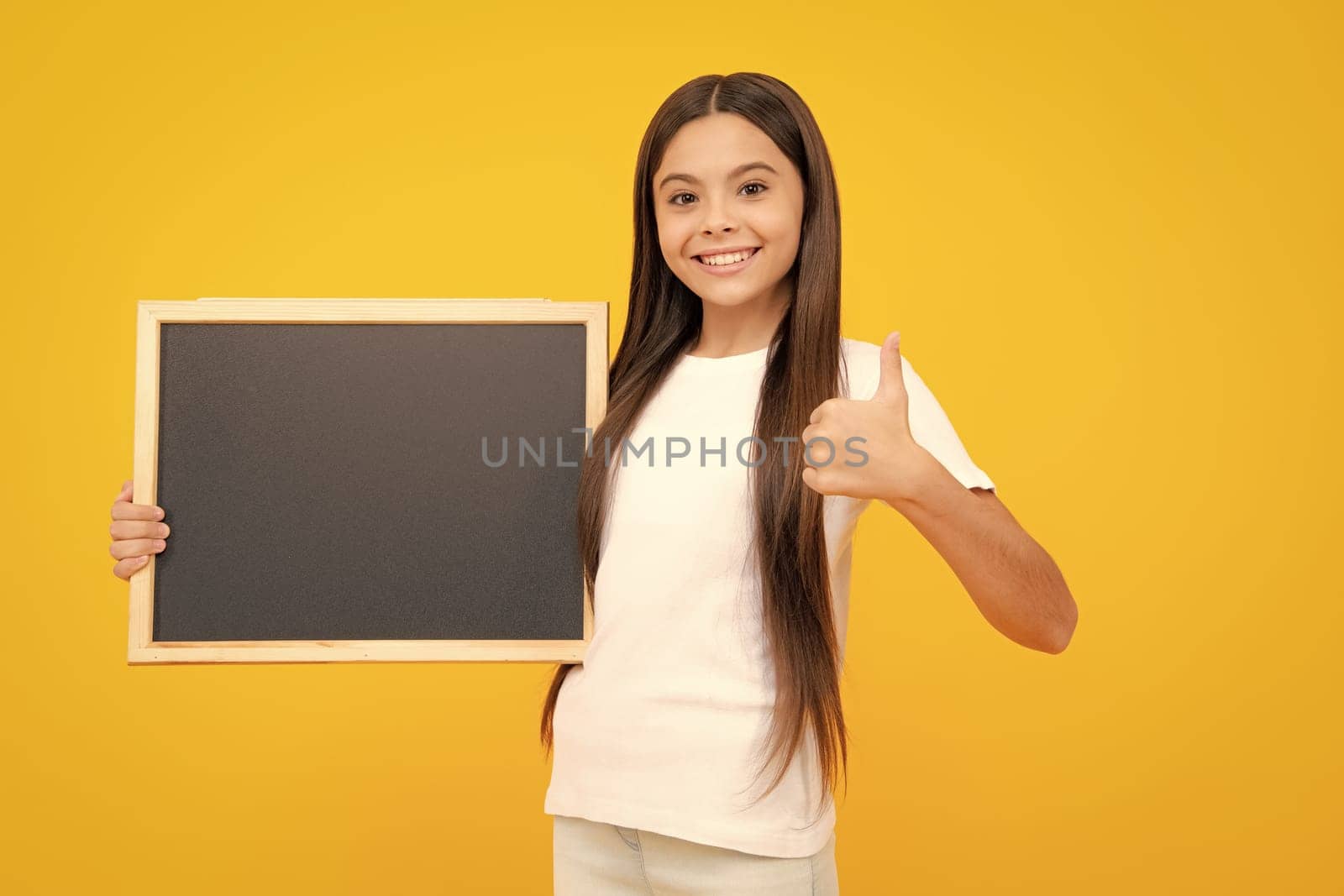 Teen schoolgirl hold blackboard. Child advertising. Back to school. Happy teenager portrait. Smiling girl. by RedFoxStudio