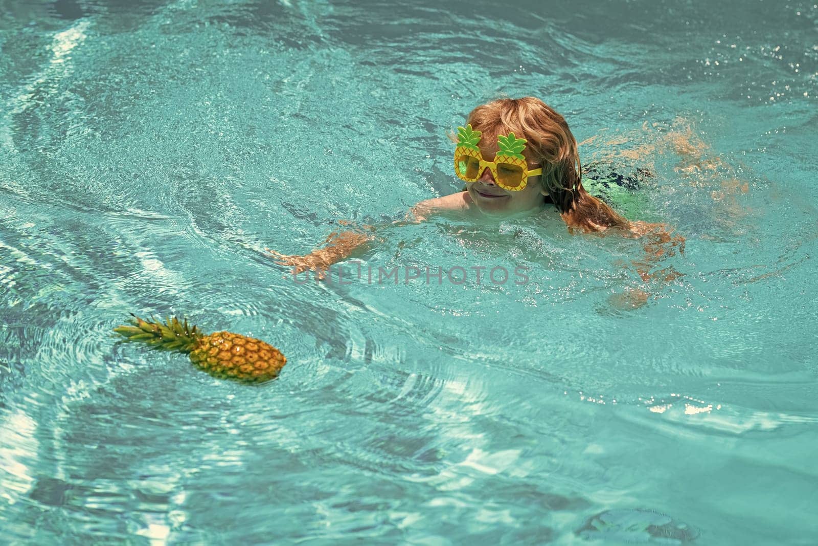 Summer beach. Kid in swimming pool, tropical sea water