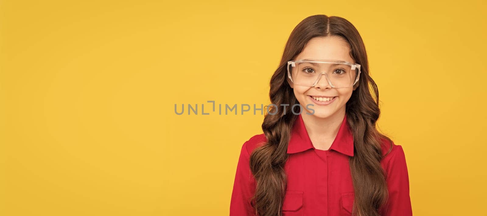 happy teenager girl improve eyesight in protective glasses. Child builder with protective glasses horizontal poster design. Banner header, copy space. by RedFoxStudio