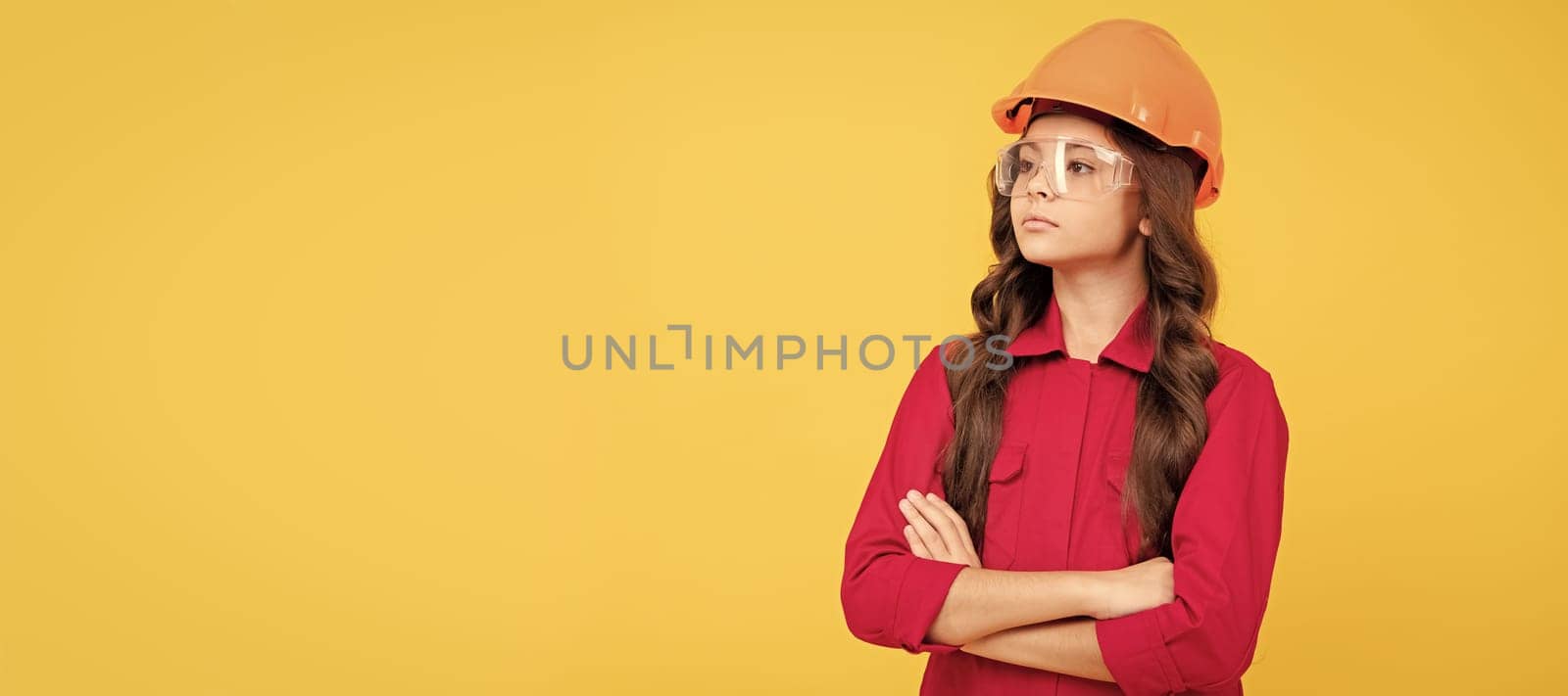 Renovation child, serious teenager girl in protective eyeglasses and helmet, copy space, building. Child builder in helmet horizontal poster design. Banner header, copy space. by RedFoxStudio