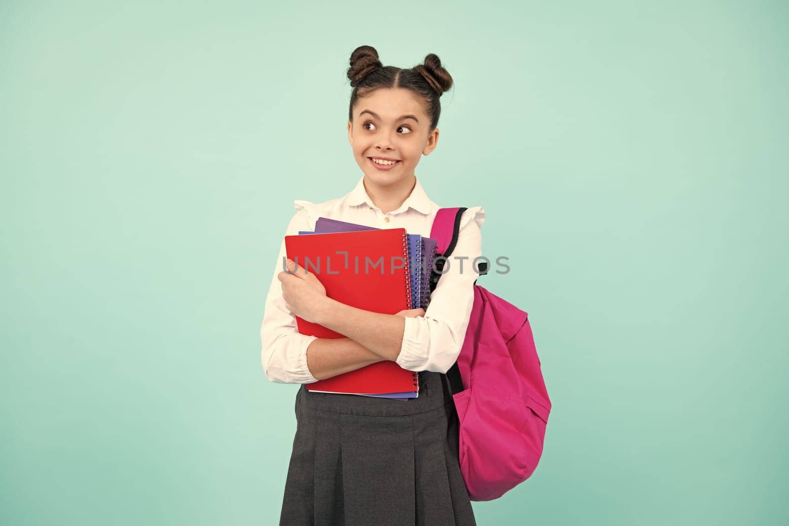 Back to school. Schoolgirl student hold book on blue isolated studio background. School and education concept. Teenager girl in school uniform. Happy teenager, positive and smiling schoolgirl. by RedFoxStudio