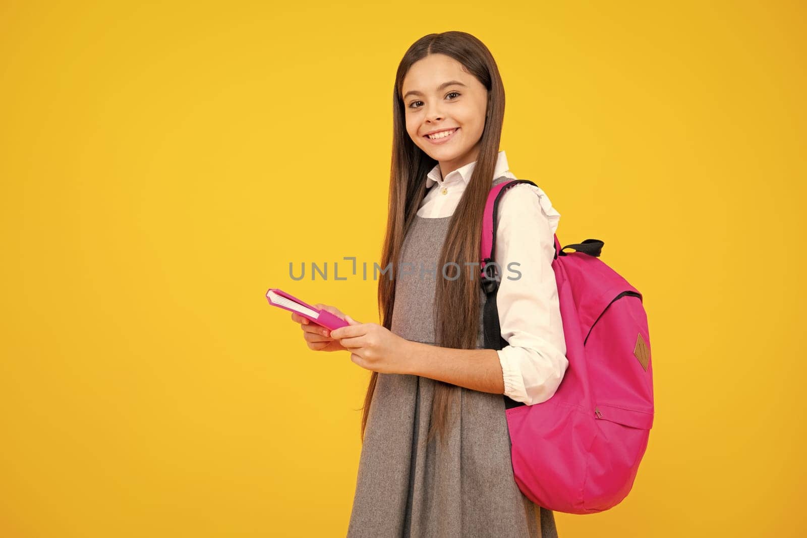 School teenage girl with book and copybook. Teenager schoolgirl student, isolated background. Learning and knowledge. Go study. Education concept