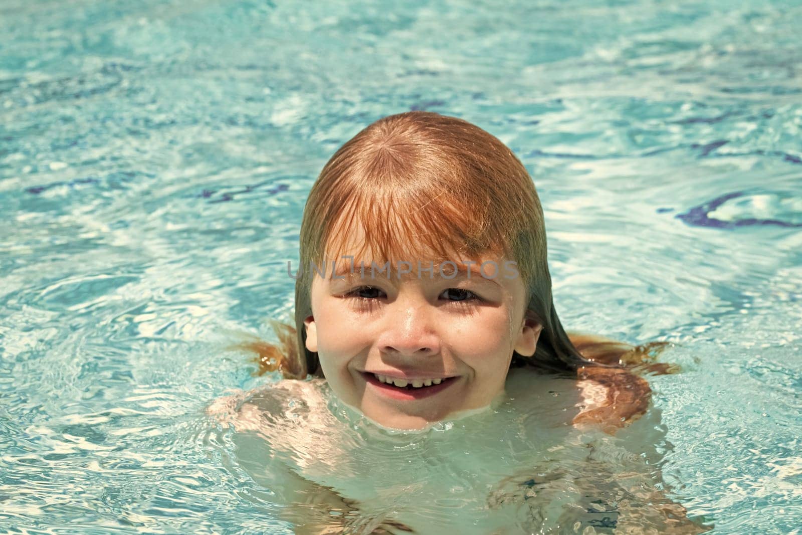 Child in swimming pool. Summer kids activity. Healthy lifestyle