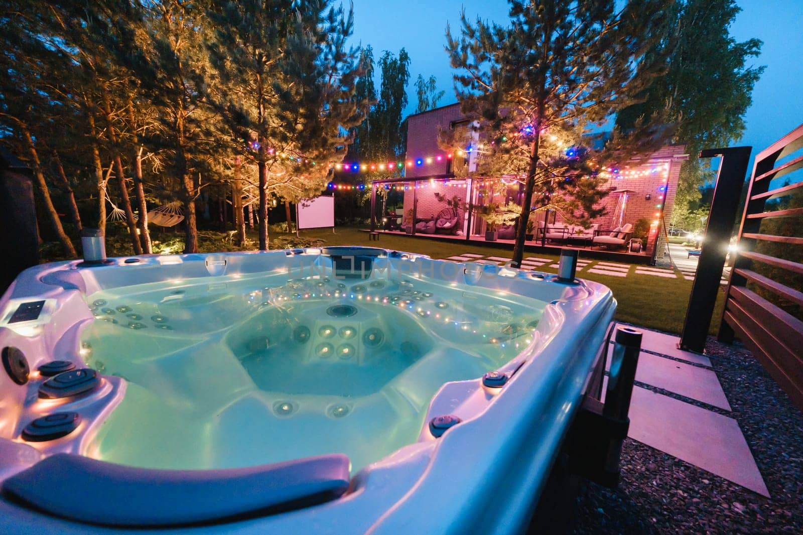 self-contained hot tub or pool with hot water and evening lighting.