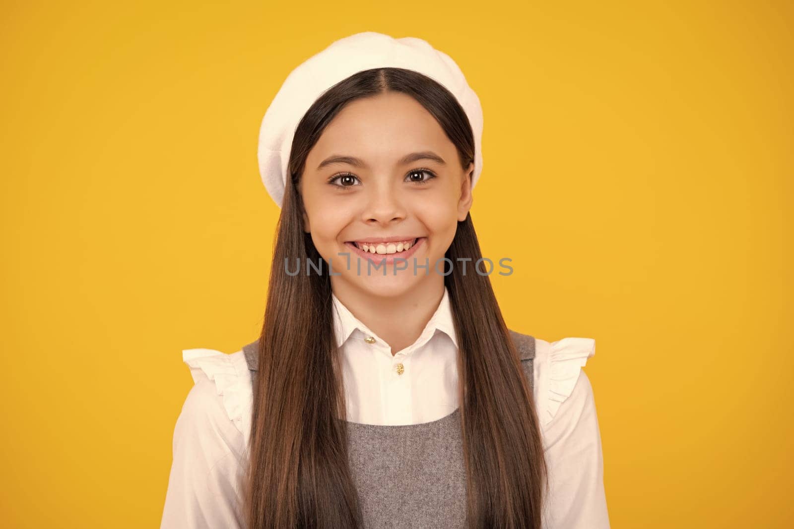 Happy face, positive and smiling emotions of teenager girl. Close-up portrait of girl teen face. Portrait of a cute teen child. Studio shot, isolated background.