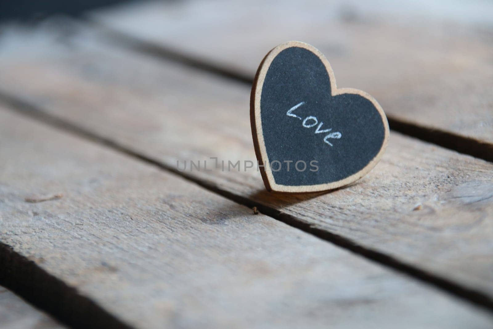 Happy birthday celebration greeting card. Love heart on a wooden background. by Markgraf