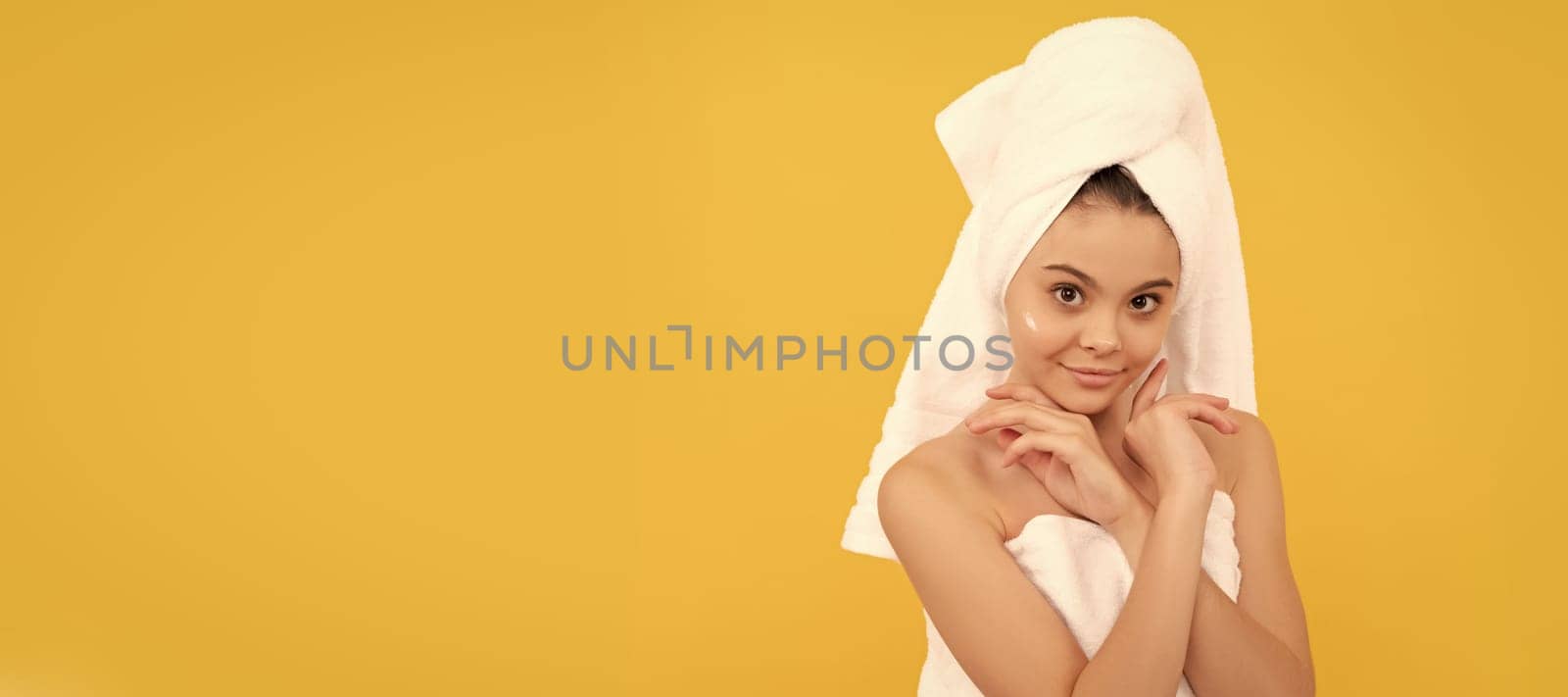 Kids facial treatment, cosmetology and spa, cheerful teen girl in shower towel with cream on face. Cosmetics and skin care for teenager child, poster design. Beauty kid girl banner. by RedFoxStudio