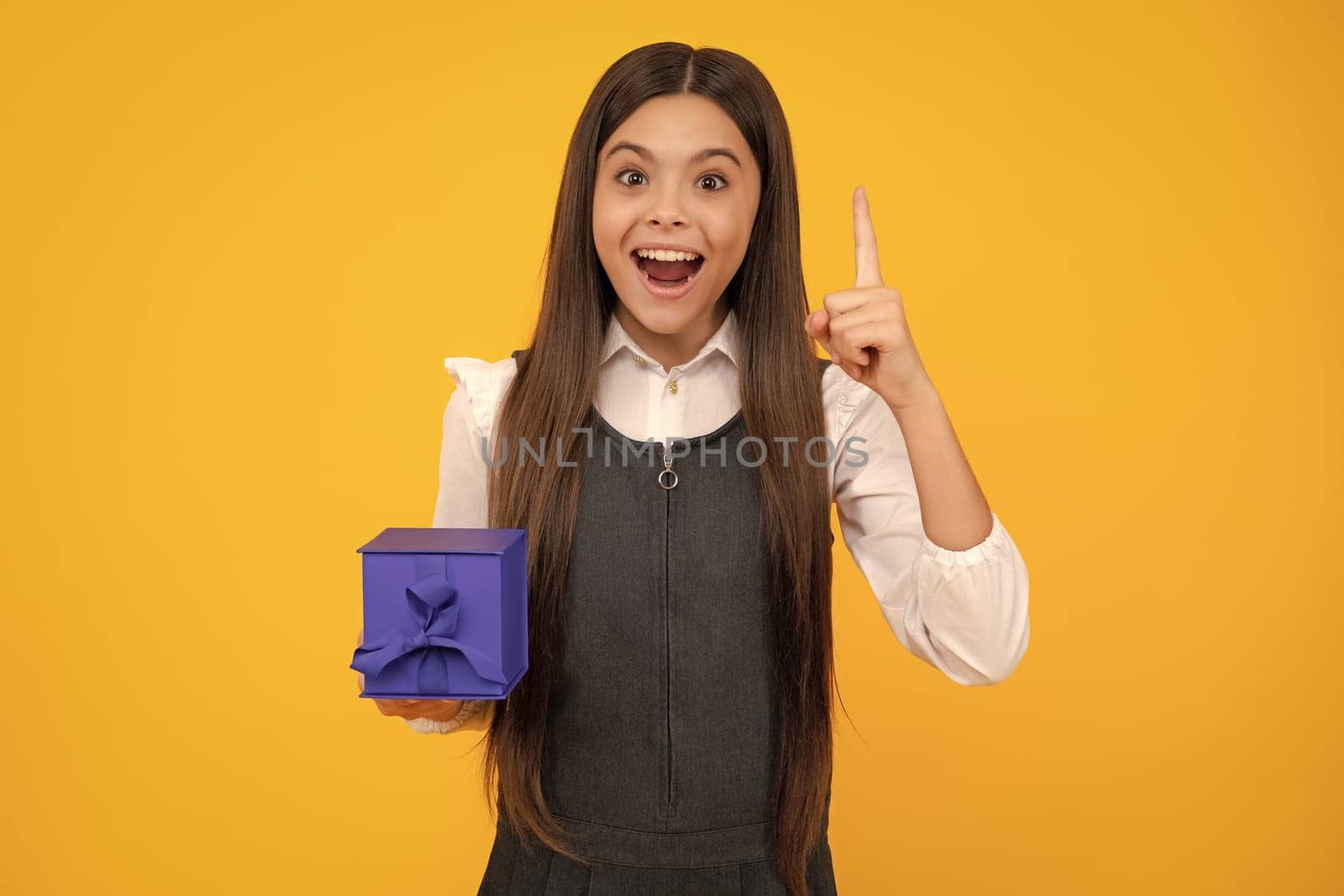 Amazed teen girl. Teenager child with gift box. Present for winter birthday, Valentines day, New Year or Christmas. Excited expression, cheerful and glad. by RedFoxStudio