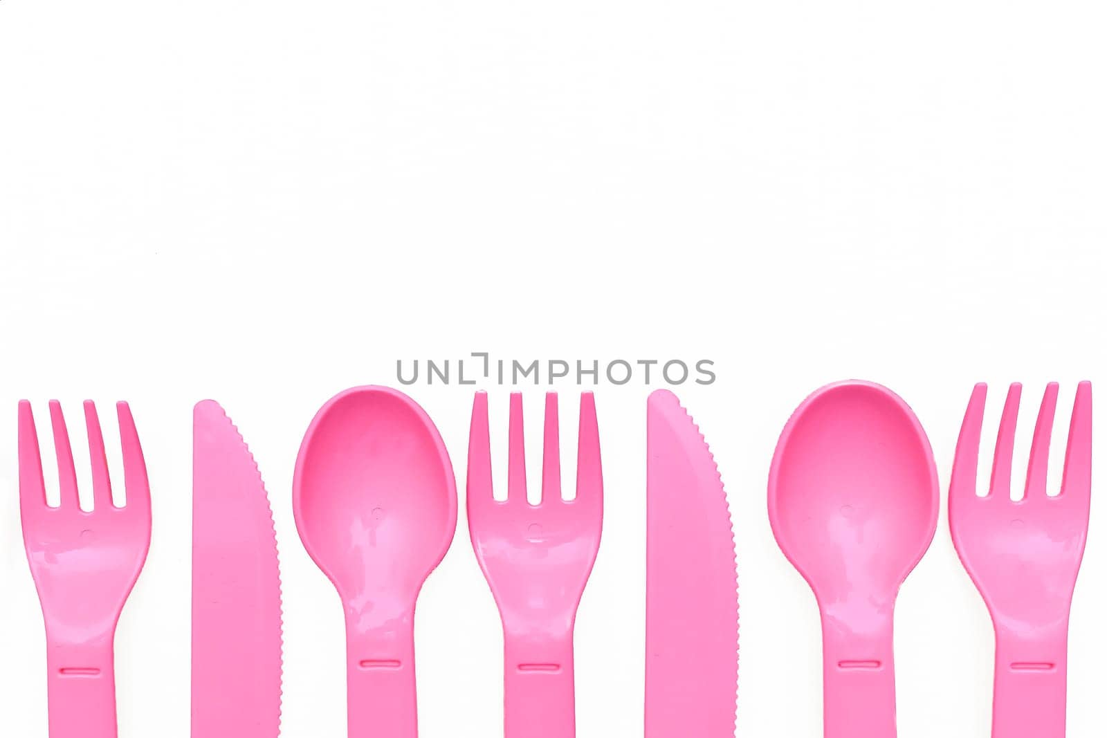 Pink plastic spoons, forks, knives for camping, isolated on white by jovani68