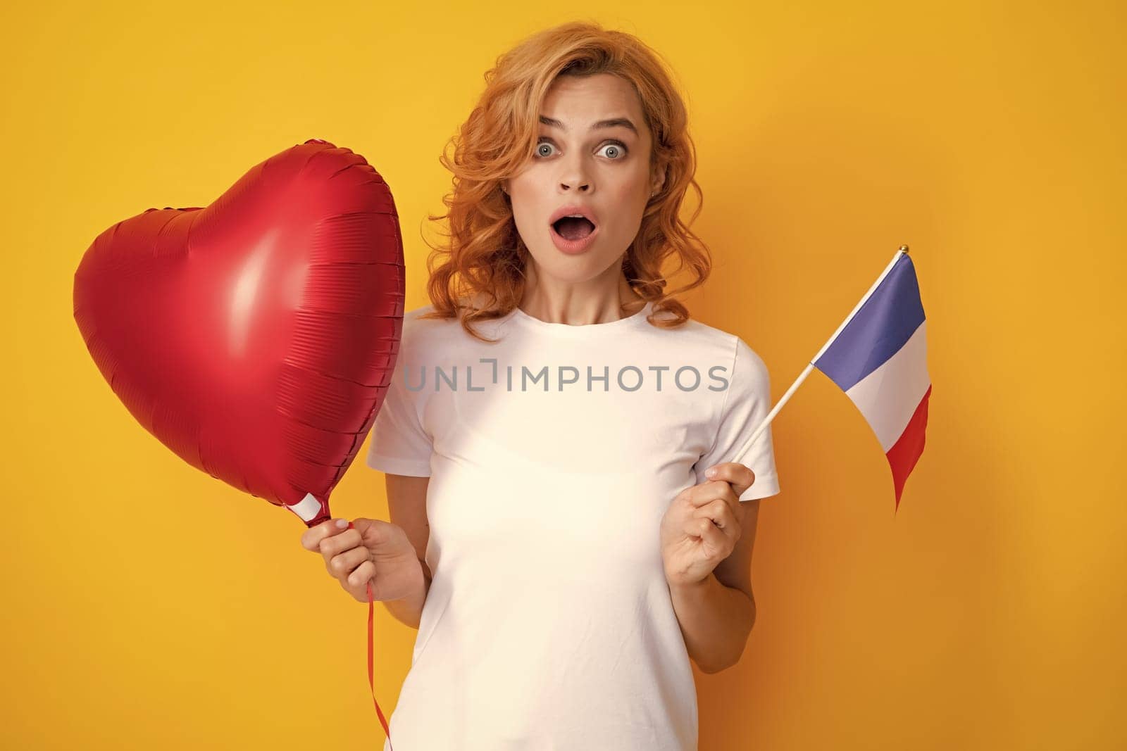 France school or university concept. Happy woman holding flag of France and red heart balloon, immigration and travelling in Europe. France flag.
