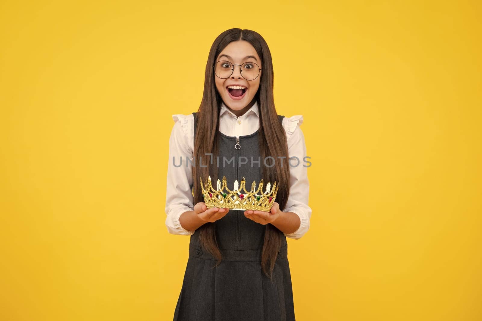 Girls party, funny kid in crown. Child queen wear diadem tiara. Cute little princess portrait. Excited face, cheerful emotions of teenager girl