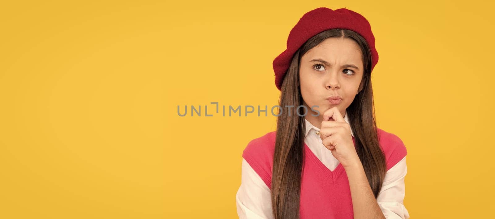 thoughtful teen school girl in french beret on yellow background, smart kid. Child face, horizontal poster, teenager girl isolated portrait, banner with copy space