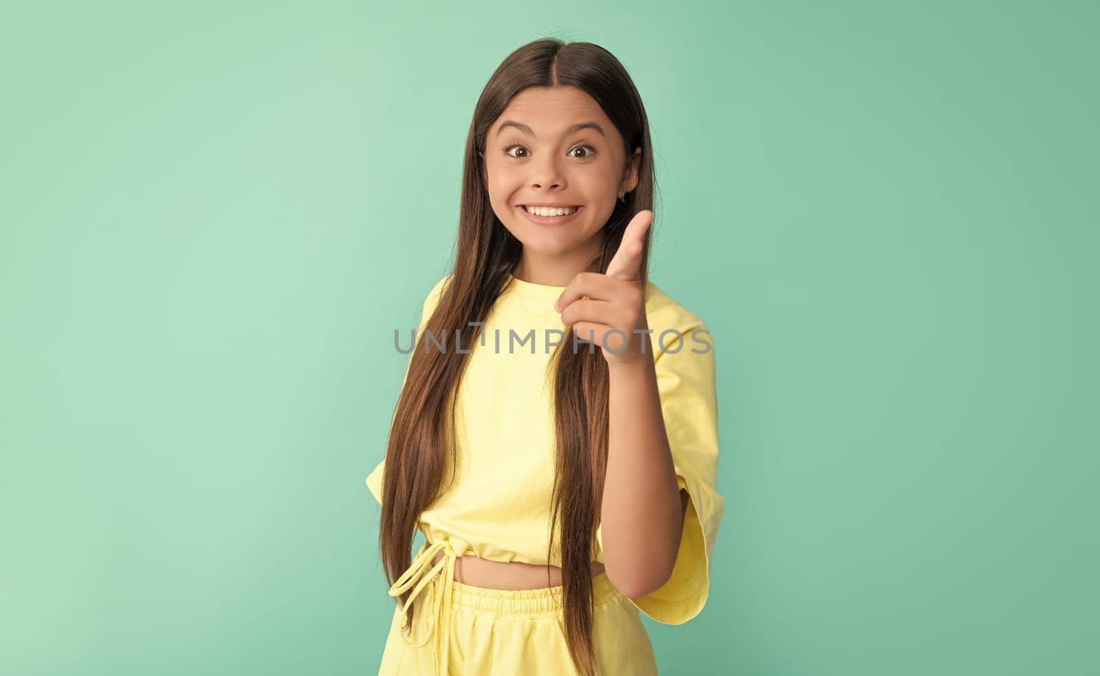 amazed child with long hair pointing finger on blue background, advertising by RedFoxStudio