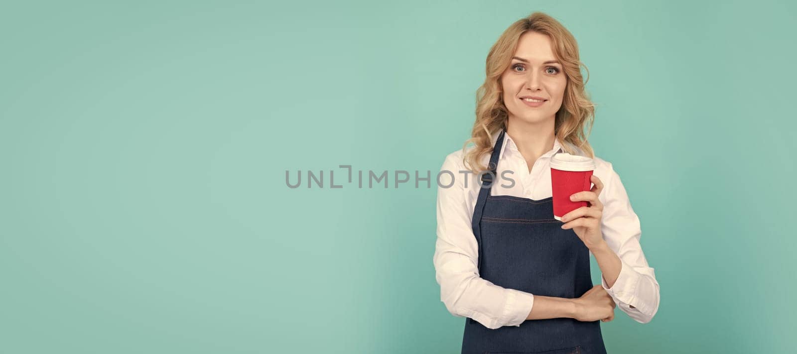 happy woman barista in cook apron drink takeaway coffee, morning. Woman isolated face portrait, banner with mock up copy space