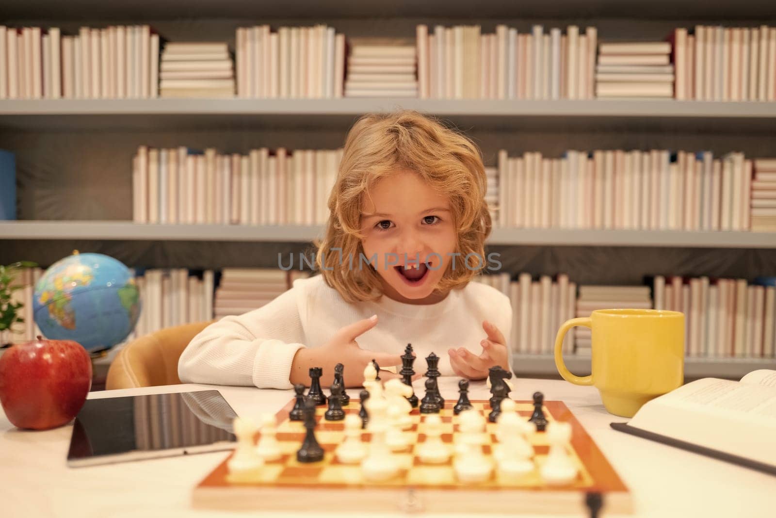Little child play chess in classroom. Kid playing board game. Thinking child brainstorming and idea in chess game. Chess school and education concept. by RedFoxStudio