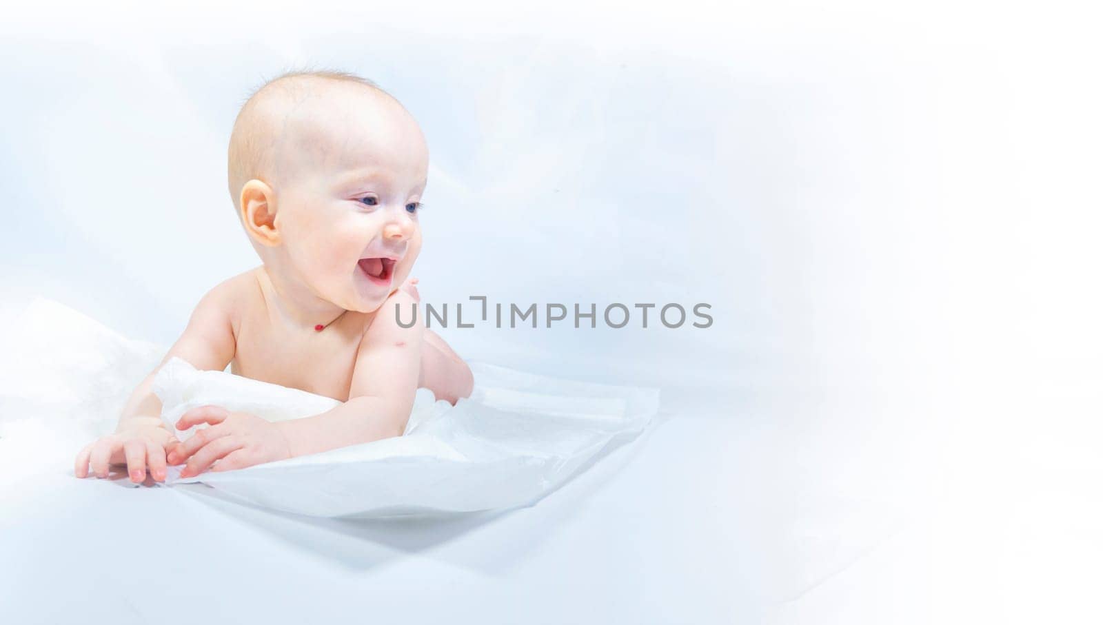 a baby with a hemangioma on his neck lies on a white background. banner with a copy space. profile of a little bald baby girl. the kid looks to the side