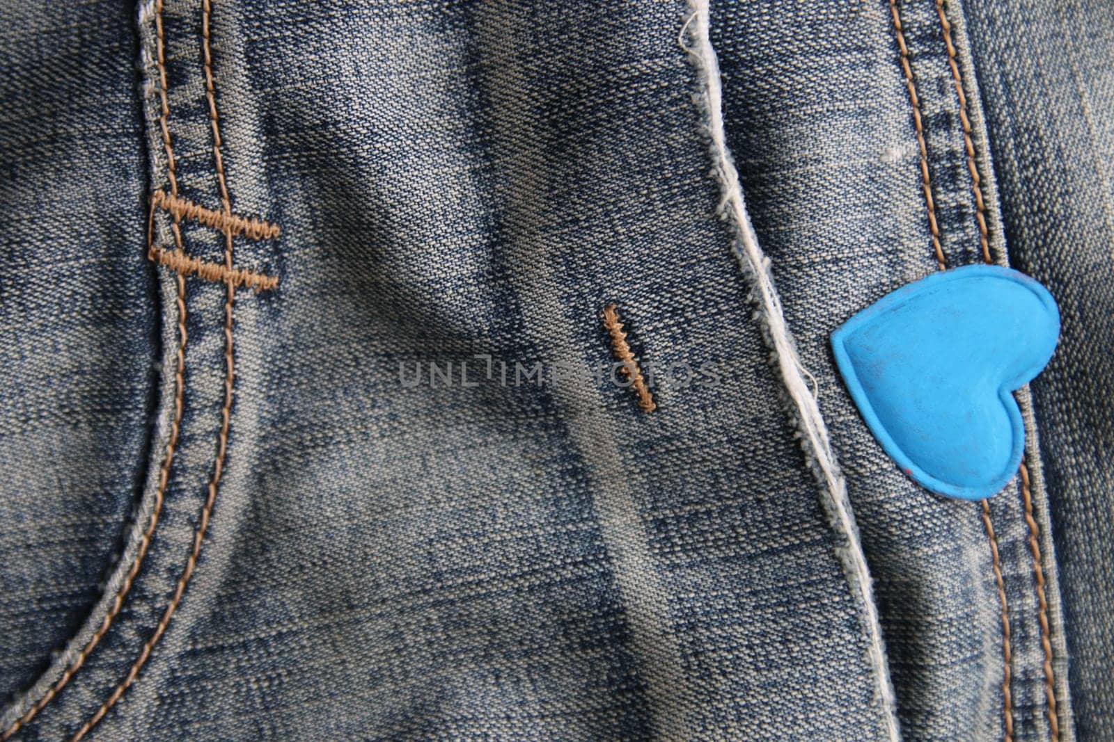 Blue heart on jeans. Creative Birthday background.