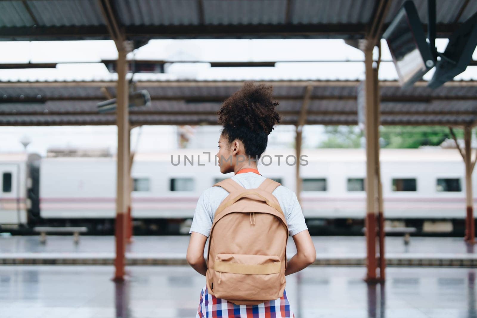 Tourists african american are showing happy expressions while waiting for their journey in the train station