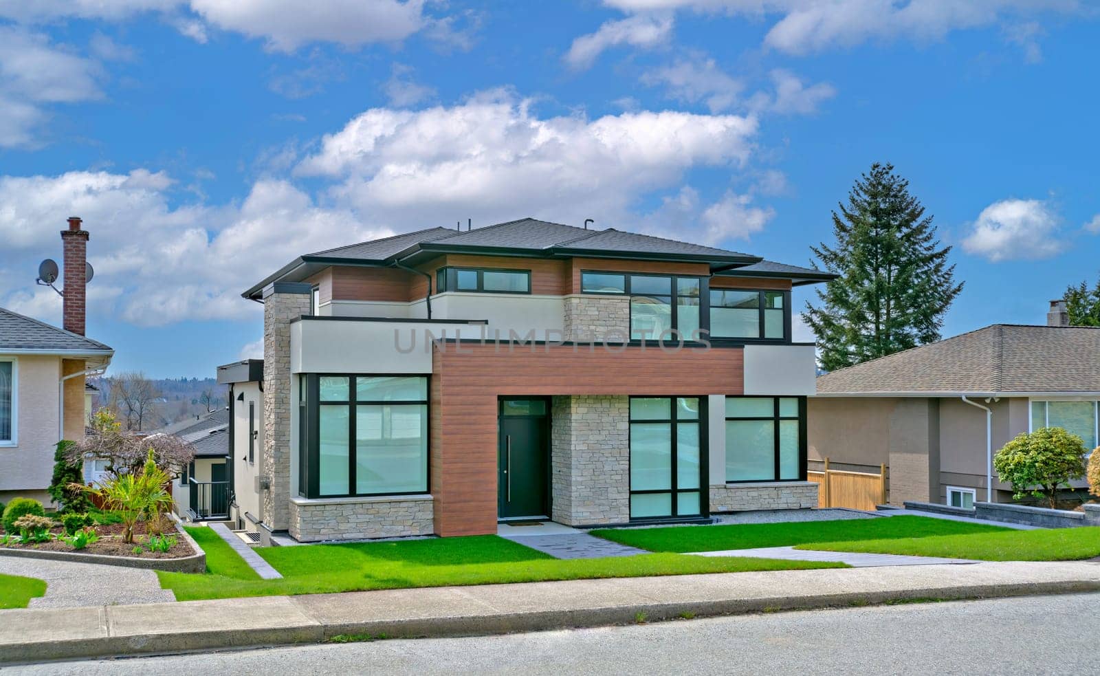 A perfect neigbourhood. Modern family house on cloudy sky background