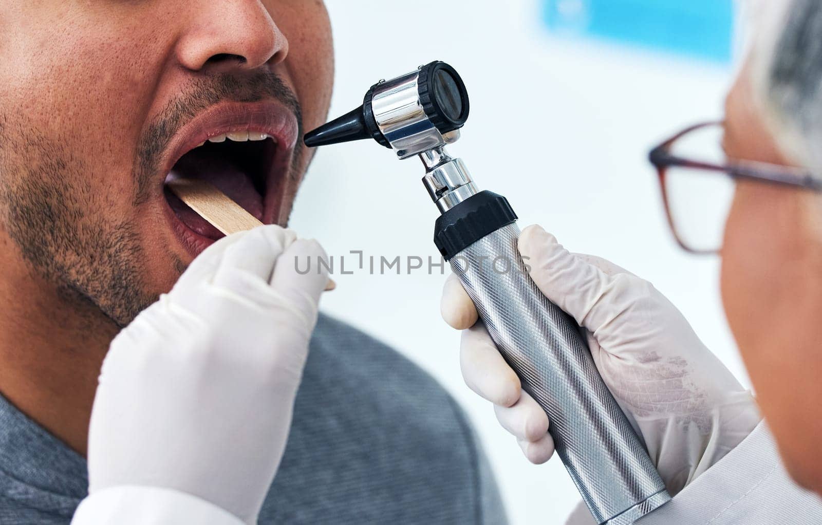 Medical, consulting and doctor with mouth of person and check for cancer, dentist or surgery. Medicine, healthcare and check up with closeup of woman and patient in clinic for wellness, virus or exam by YuriArcurs