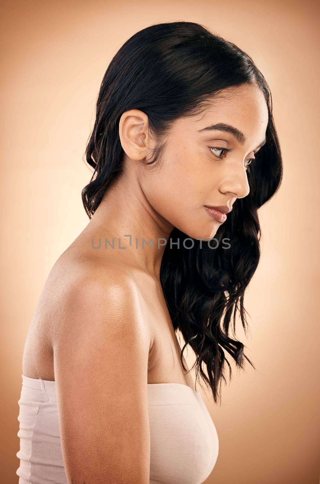 Thinking, texture and woman with hair care, salon treatment and self care against a brown studio background. Female person, girl and model with ideas, aesthetic and skincare with beauty and luxury.