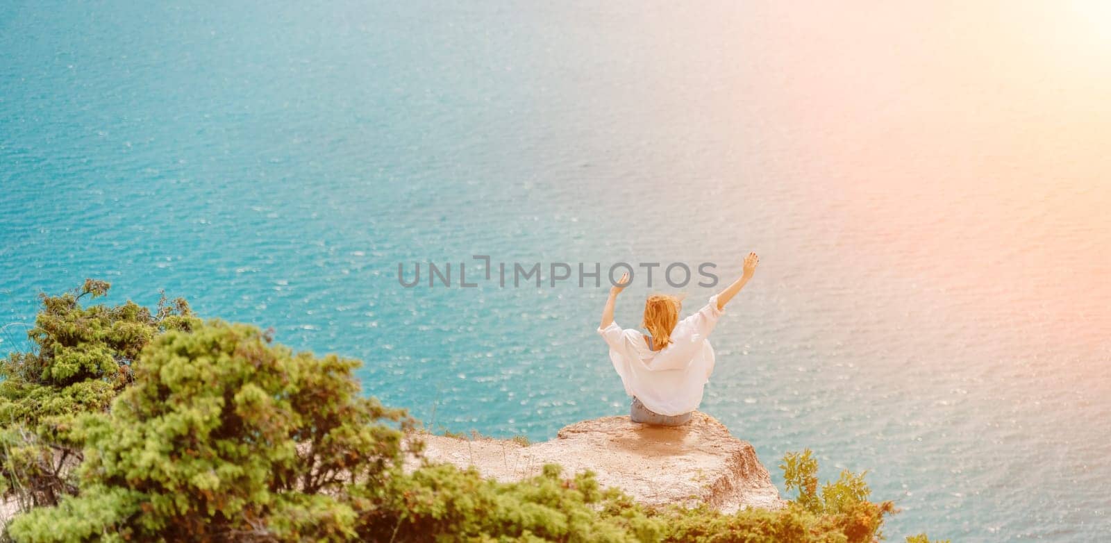 Woman travel summer sea. Portrait of a happy woman on a background of beautiful sea. Rear view of a woman in a white shirt. Freedom and happiness.