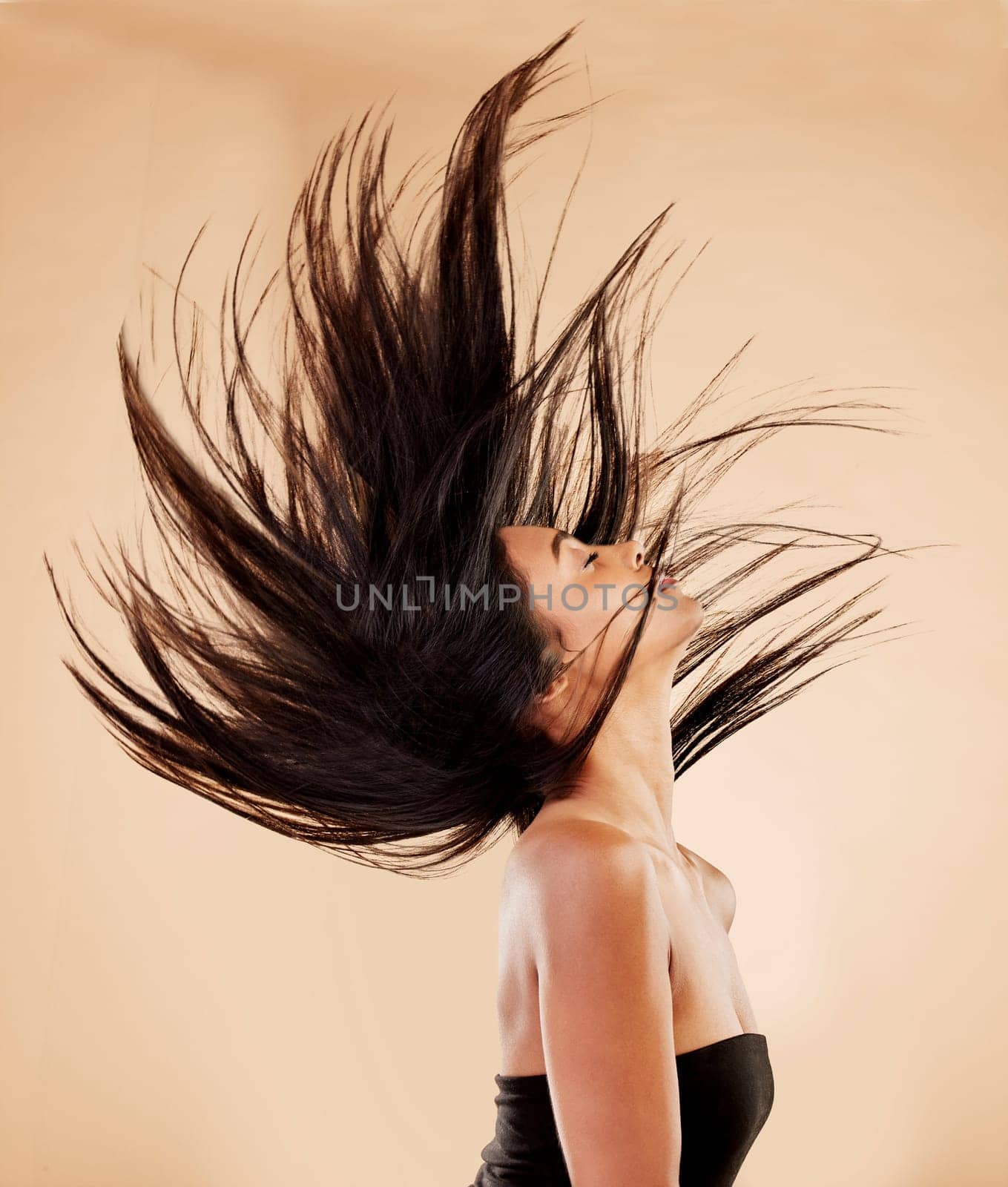 Woman, hair in air and beauty with cosmetics, keratin treatment and shine isolated on studio background. Female model profile, wind and haircare with cosmetology, Brazilian and texture with growth by YuriArcurs