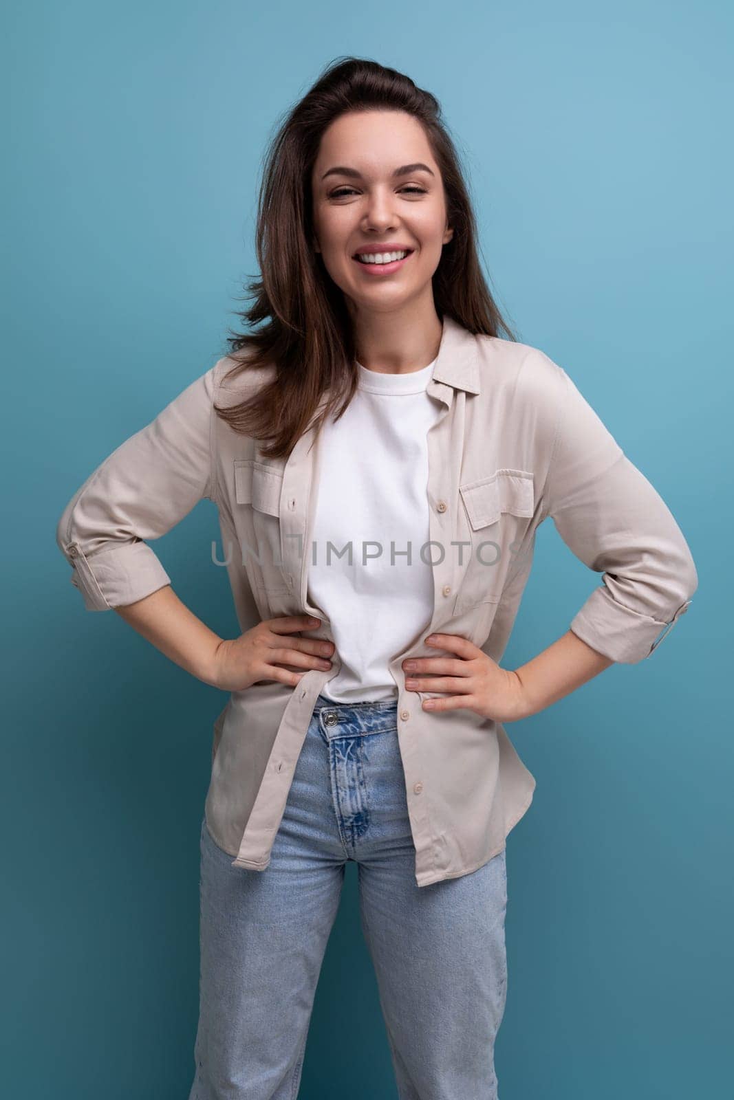 romantic charming brunette 30 year old female person dressed in a shirt and jeans on a studio background by TRMK