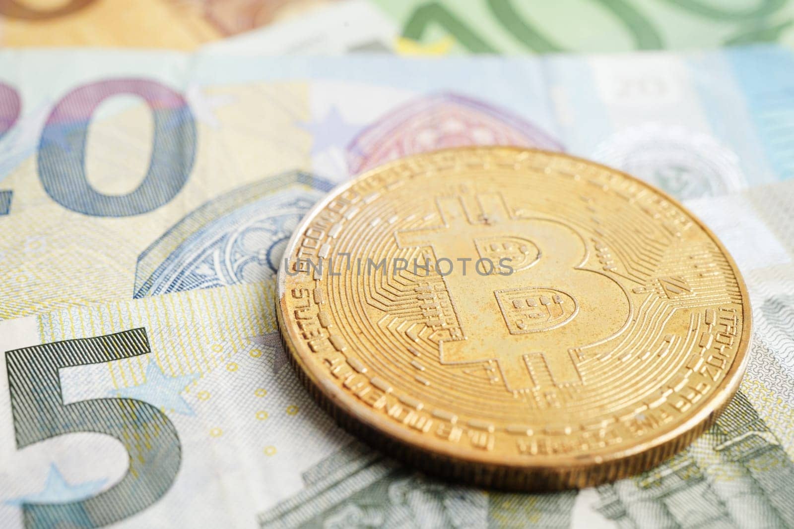 Golden bitcoin on Euro banknotes money for business and commercial, Digital currency, Virtual cryptocurrency.      