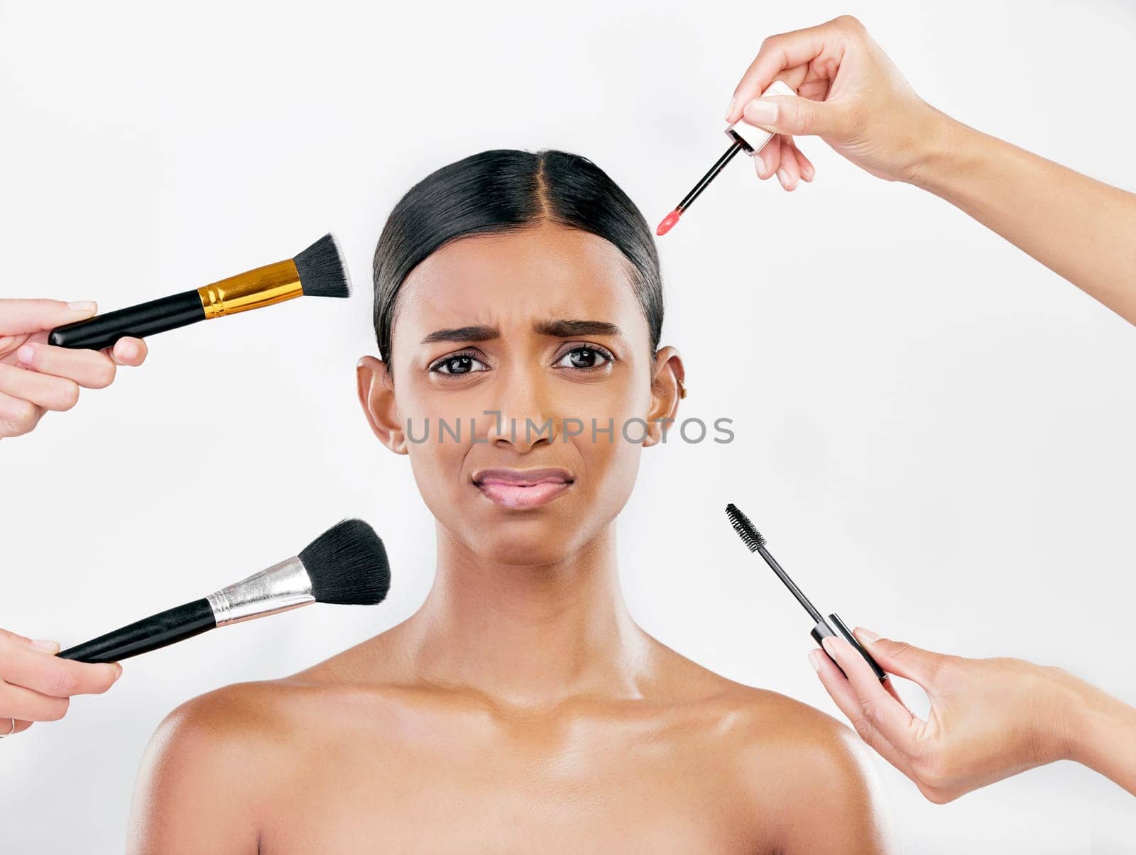 Makeup, brush and anxiety, woman with beauty shine and overwhelmed with beautician on white background. Doubt with cosmetics, tools and hands crowd female model in studio, cosmetology and skin glow.