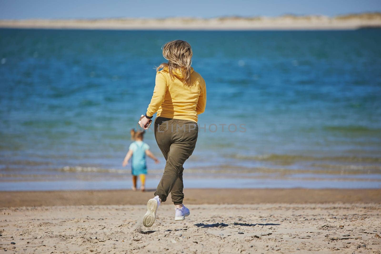 Mom catches up with her daughter on the beach in Denmark.
