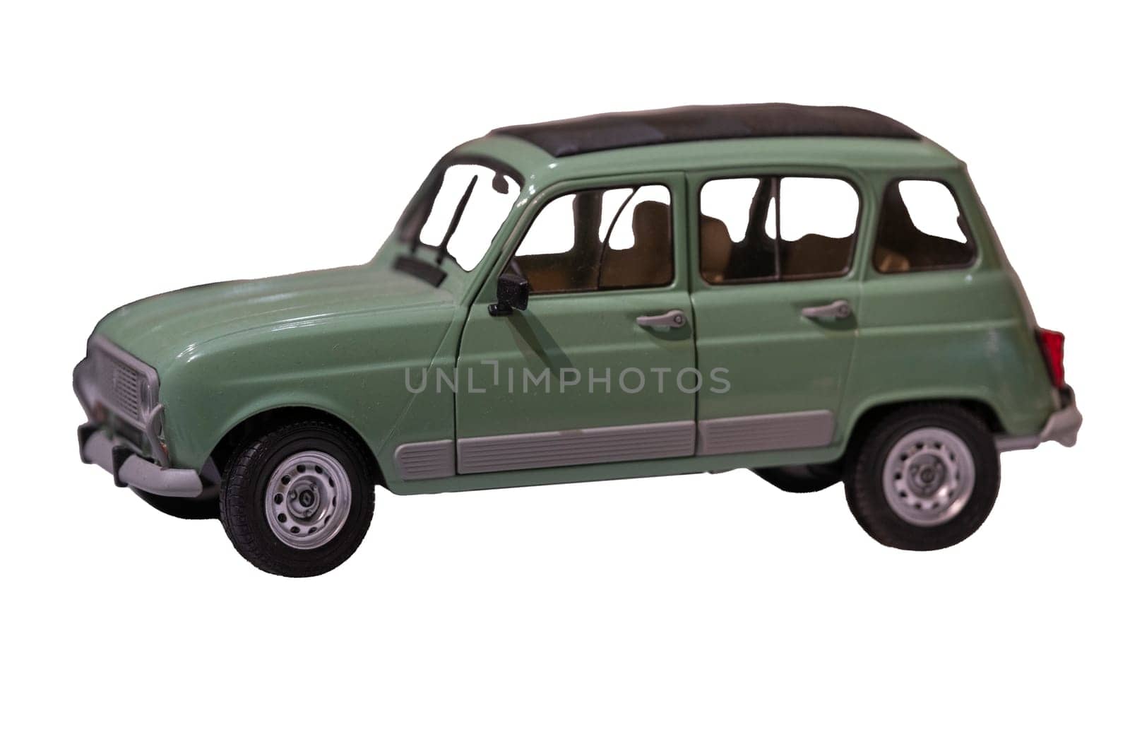 A scale model of a mint pastel green vintage car from 1950-60s. Car is a 4 door station wagon and has a roll off leather or canvas top. Isolated on white with clipping path. Focus on foreground