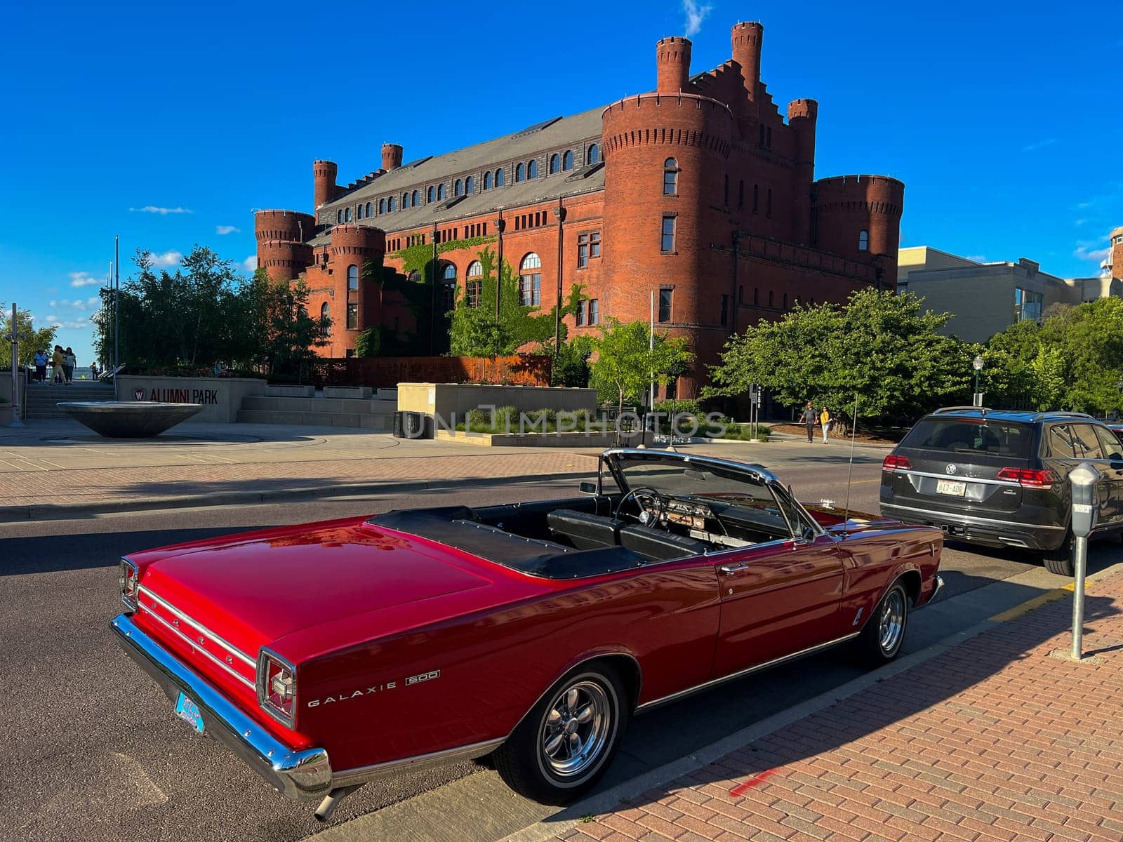 MADISON, WISCONSIN, JULY 14 2022: Ford Galaxie 500 with background of Wisconsin State University old stye building in the city with a blue sky summer background. High QUality Image.