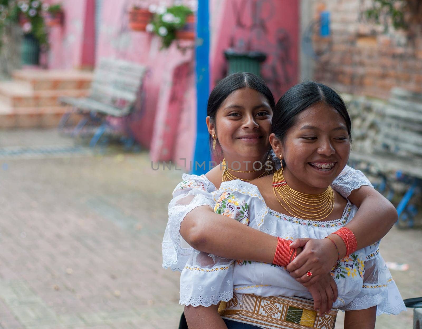 copyspace of two friends with traditional dresses in a park in latin america very happy. High quality photo