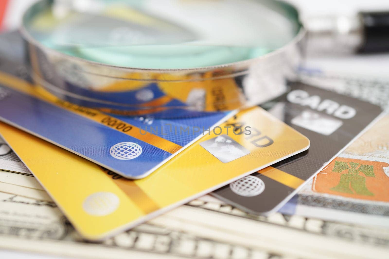 Credit card and magnifying glass for online shopping, security finance business concept.