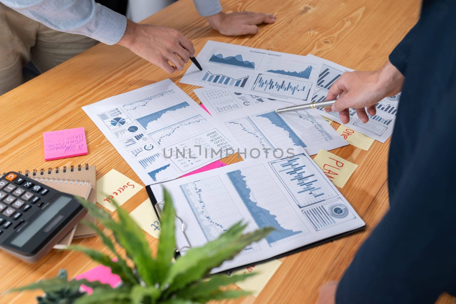 Analyst team in office analyzing financial data analysis for marketing strategy in workspace, pile of BI dashboard paper format with graph and chart to optimize performance and risk management. Entity