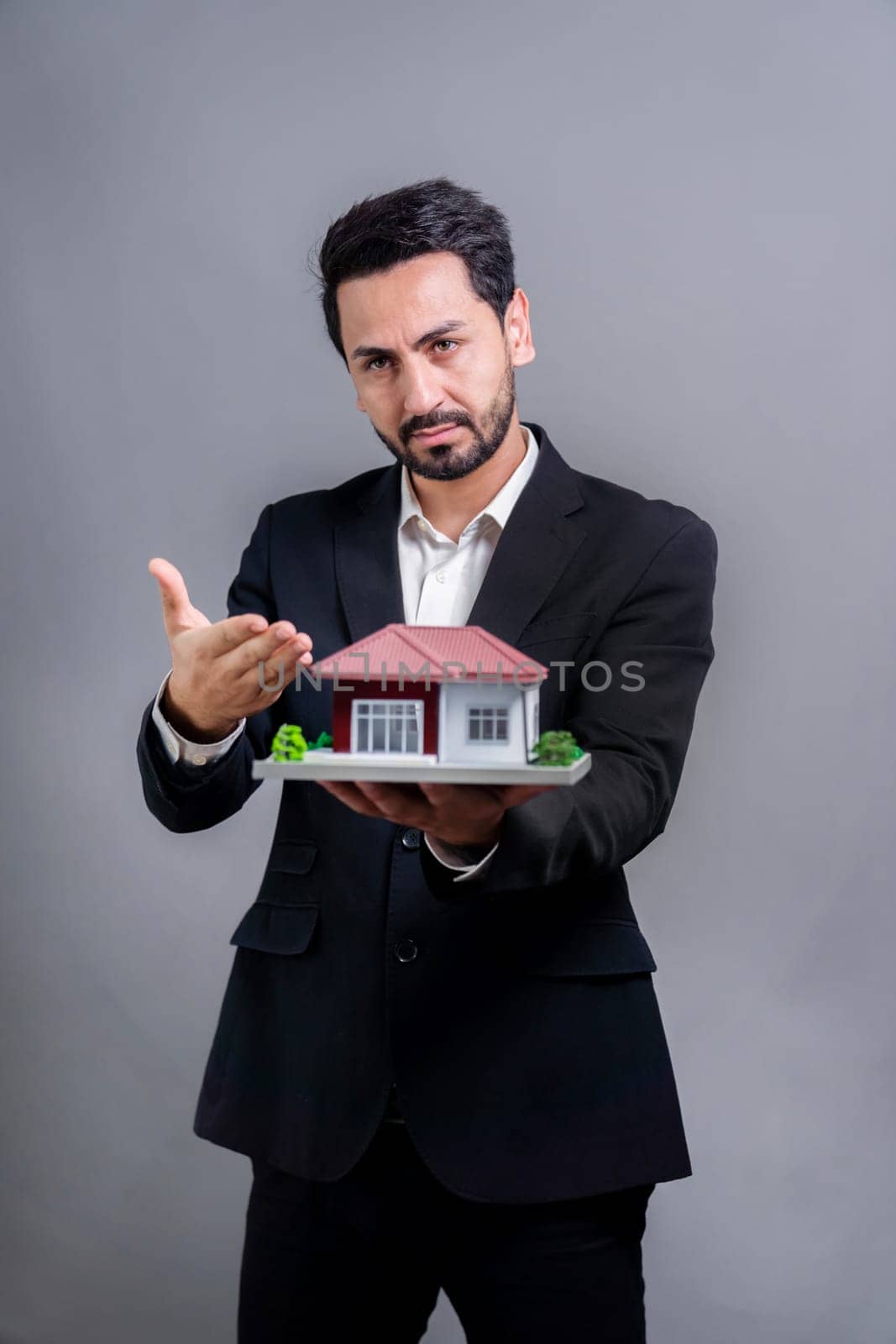 Real estate agent hold house model sample on isolated background. Fervent by biancoblue