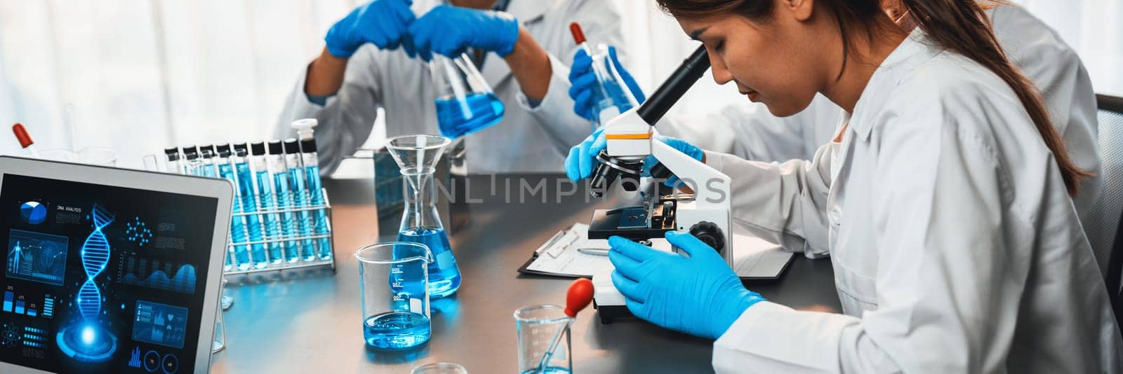 Dedicated scientist group working on advance biotechnology computer software to study or analyze DNA data after making scientific breakthrough from chemical experiment on medical laboratory. Neoteric