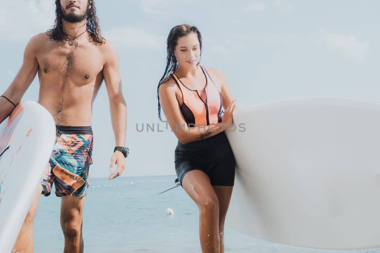 Woman man sea sup. Close up portrait of beautiful young caucasian woman with black hair and freckles looking at camera and smiling. Cute woman portrait in a pink bikini posing on sup board in the sea. by panophotograph