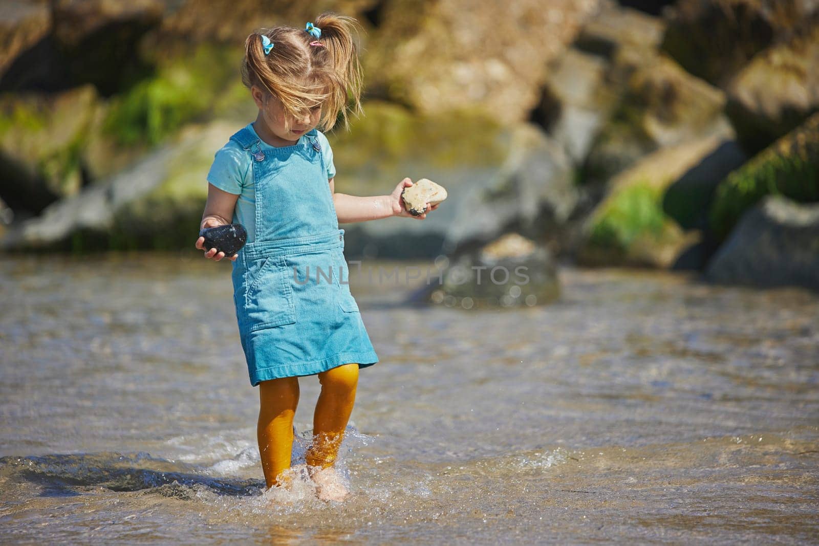 Charming child throws a stone into the sea in Denmark by Viktor_Osypenko