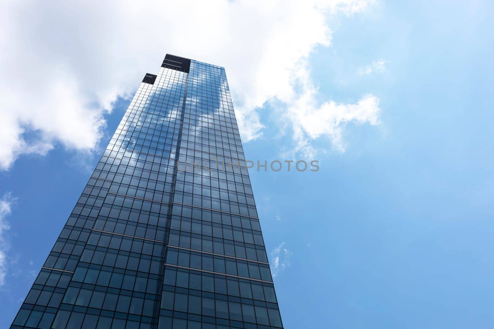 Downtown, Glass Skyscraper Or Tower and Blue Shiny Sky on Background. Business Development Or Financial Center concept. Copy Space on Right. Horizontal Plane. Modern Building. High quality photo