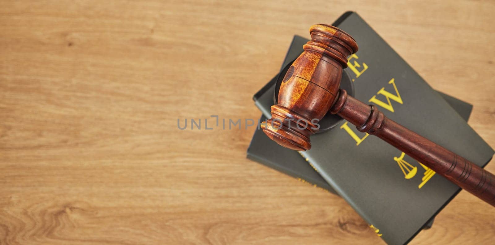 Gavel, law and books on wooden table, space or mockup for judge, justice or lawyer in courtroom. Background, hammer and research knowledge for legal study, constitution and truth, litigation or trial by YuriArcurs
