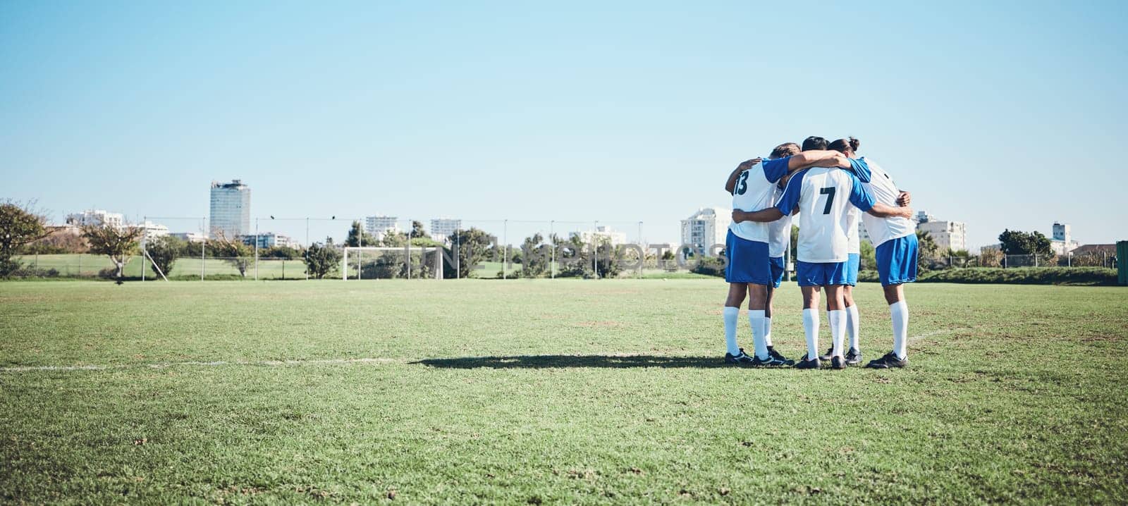 Sports, mockup and a team of soccer players in a huddle on a field for motivation before a game. Football, fitness and training with man friends getting ready for competition on a pitch together.