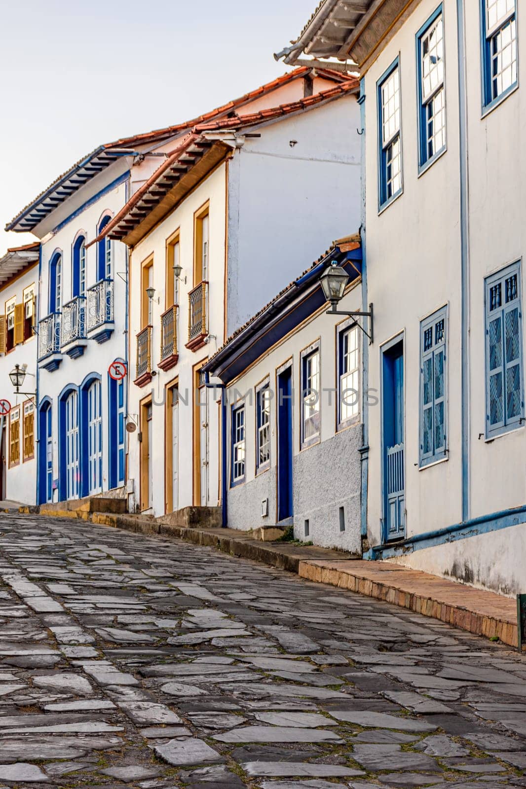 Slope with stone pavement and colonial houses by Fred_Pinheiro