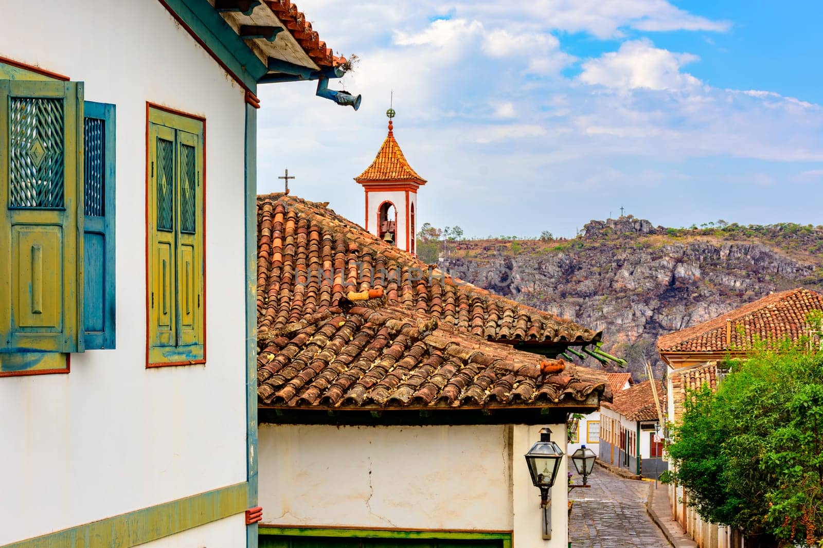 Street in the city of Diamantina with its colonial-style houses and colorful balconies with the church tower in the background